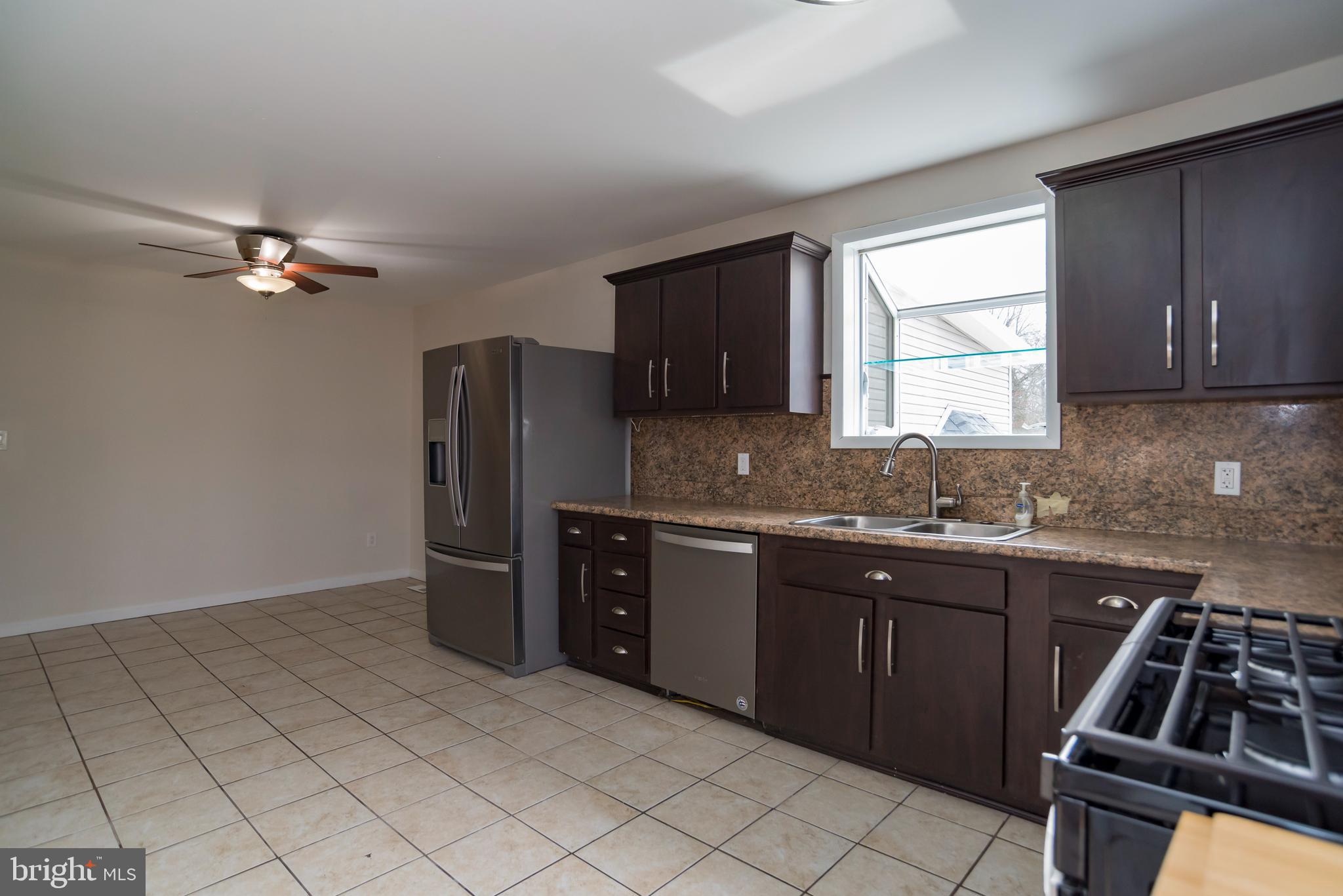 2427 Buttonwood Lane Millville, NJ 08332 - Photo 10 of 58 a kitchen with stainless steel appliances granite countertop a refrigerator and a sink