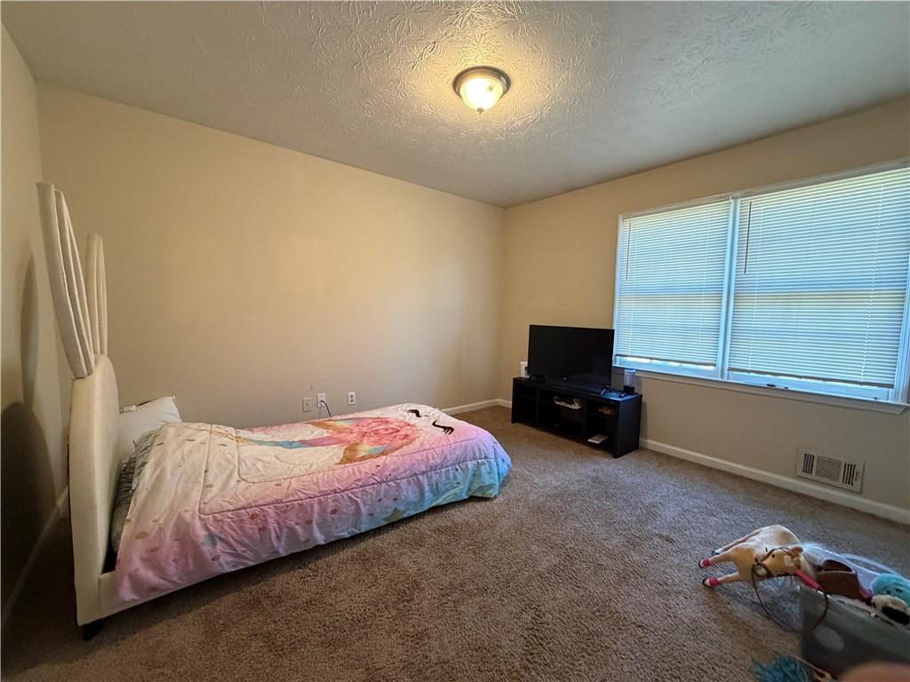 310 Bedford Bay Lane Lawrenceville, GA 30046 - Photo 12 of 23 a bedroom with a bed and a window