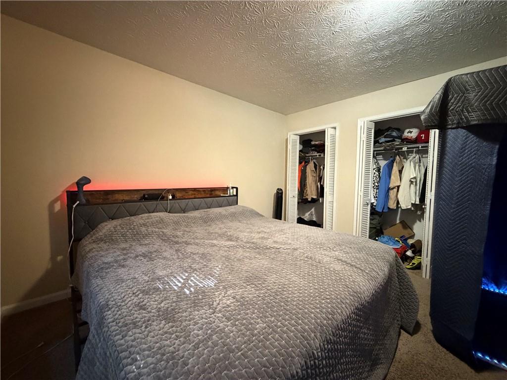 310 Bedford Bay Lane Lawrenceville, GA 30046 - Photo 14 of 23 a bed sitting in a bedroom next to a window