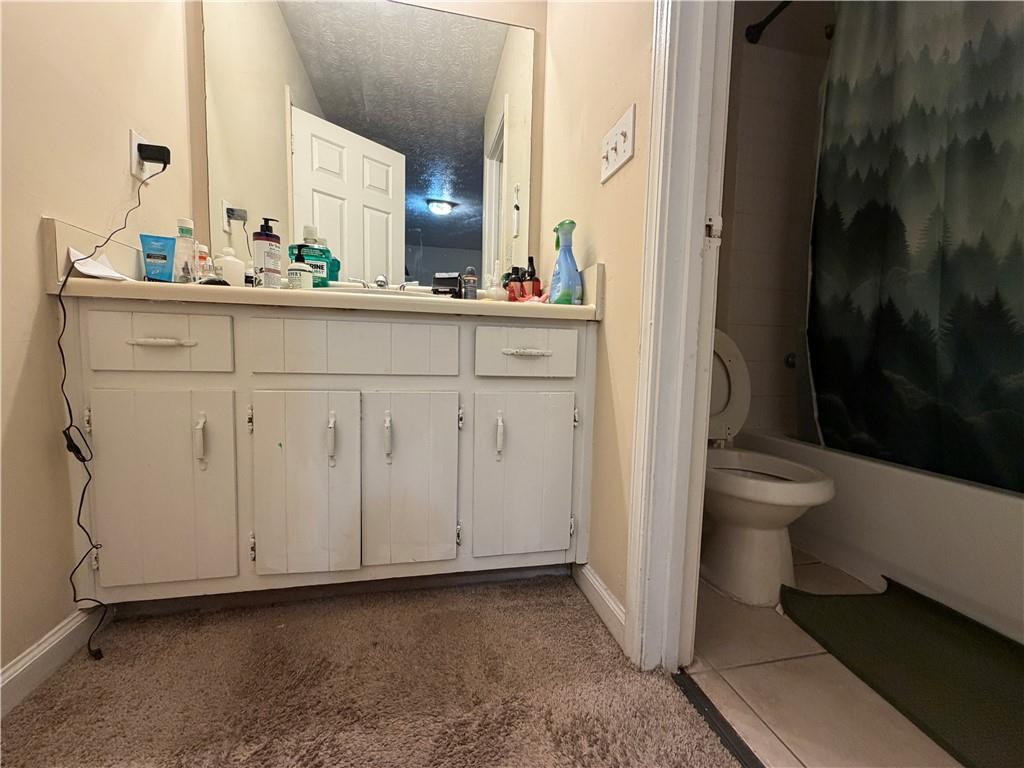 310 Bedford Bay Lane Lawrenceville, GA 30046 - Photo 15 of 23 a bathroom with a sink a toilet and a mirror