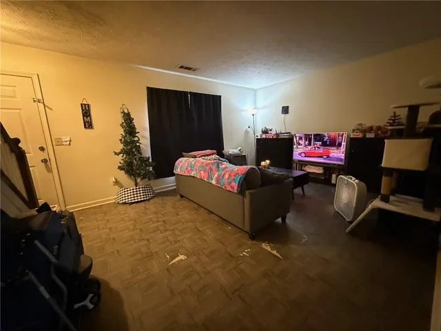 a kitchen with refrigerator and chairs