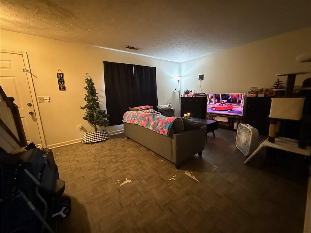 310 Bedford Bay Lane Lawrenceville, GA 30046 - Photo 18 of 23 a living room with furniture and a flat screen tv