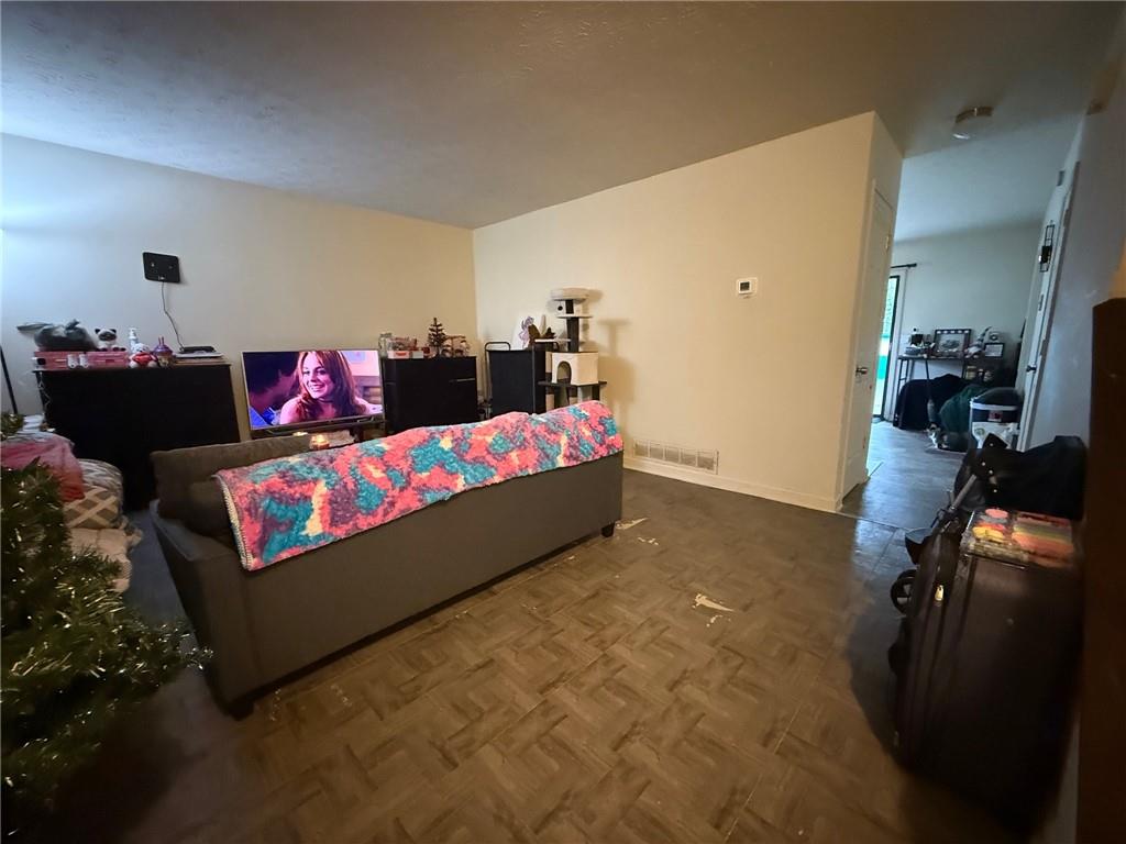 310 Bedford Bay Lane Lawrenceville, GA 30046 - Photo 19 of 23 a living room with furniture and a flat screen tv
