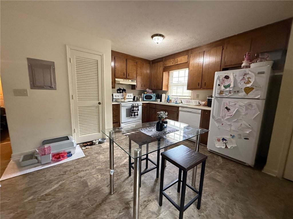 310 Bedford Bay Lane Lawrenceville, GA 30046 - Photo 20 of 23 a kitchen with refrigerator and chairs