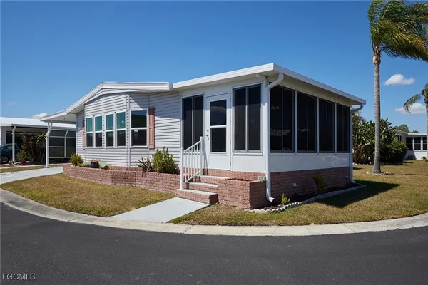 a front view of a house with a yard and porch