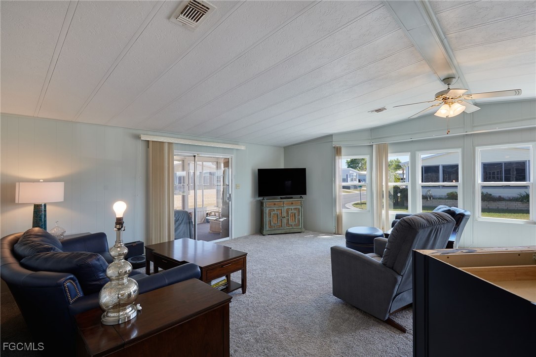 15 Ilex Street Alva, FL 33920 - Photo 12 of 43 a living room with furniture a flat screen tv and a large window