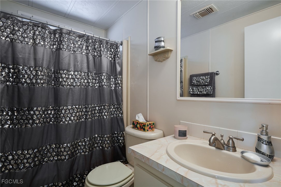 15 Ilex Street Alva, FL 33920 - Photo 20 of 43 a bathroom with a sink toilet and shower