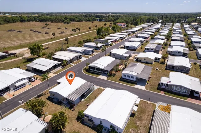 an aerial view of a city with lots of residential buildings and mountain view in back