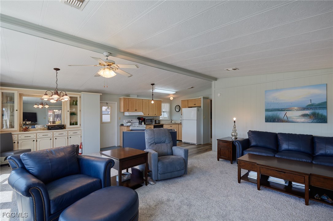 15 Ilex Street Alva, FL 33920 - Photo 10 of 43 a living room with furniture and a chandelier