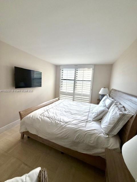 1121 Crandon Boulevard, Unit D702 Key Biscayne, FL 33149 - Photo 11 of 51 a bedroom with a bed and a flat screen tv