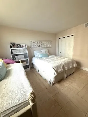 a large white kitchen with a large window and stainless steel appliances