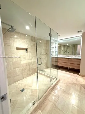 a view of a bathroom with a sink and mirror