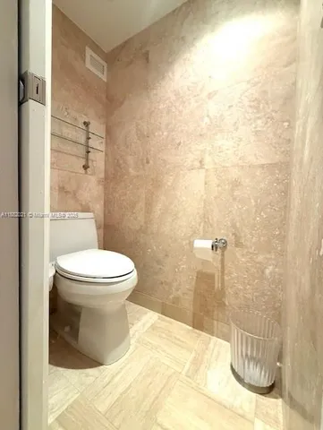 a bathroom with a mirror and a shower