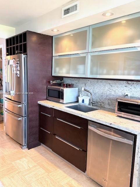 1121 Crandon Boulevard, Unit D702 Key Biscayne, FL 33149 - Photo 4 of 51 a kitchen with stainless steel appliances a sink and a refrigerator