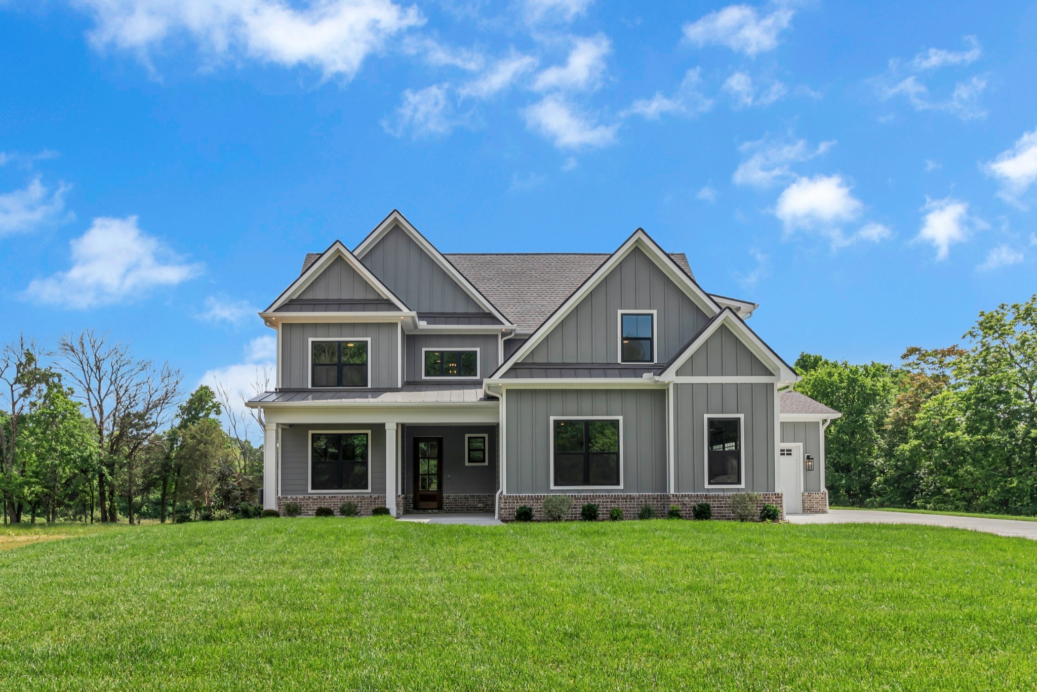 7004 Twelve Corners Road Lascassas, TN 37085 - Photo 2 of 67 a front view of a house with a garden