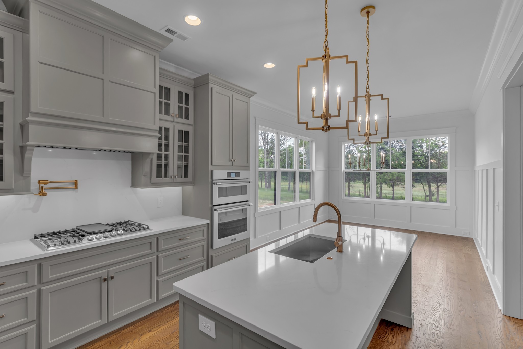 7004 Twelve Corners Road Lascassas, TN 37085 - Photo 41 of 67 a kitchen with stainless steel appliances granite countertop a sink a stove and a wooden floors