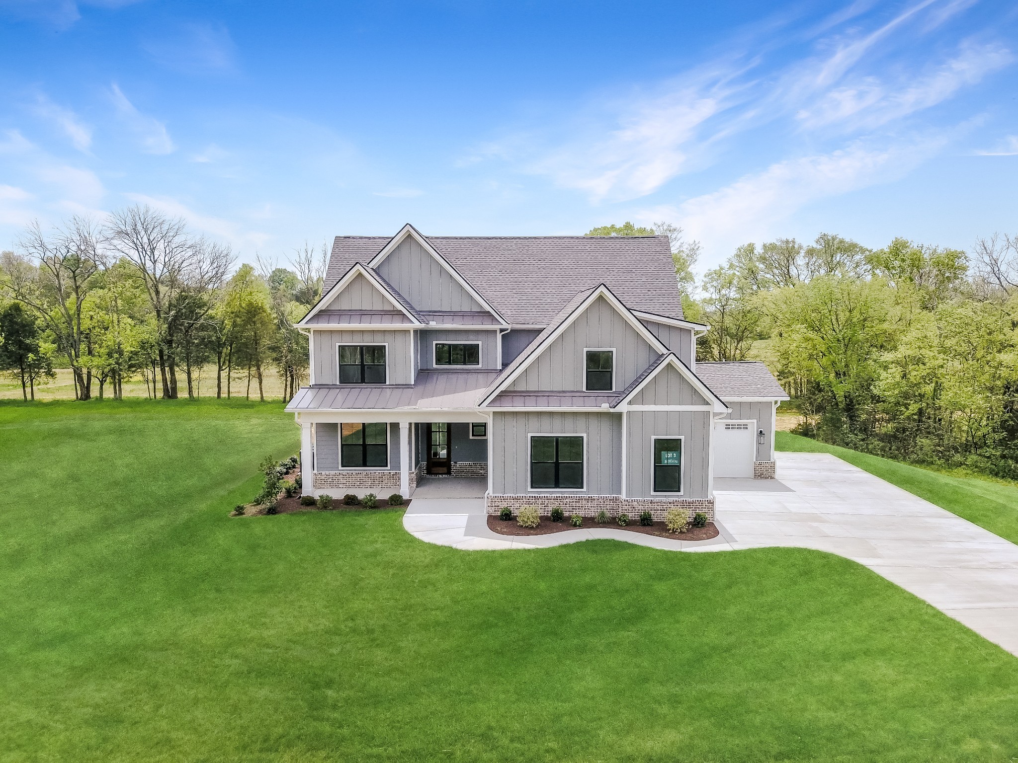 7004 Twelve Corners Road Lascassas, TN 37085 - Photo 5 of 67 a front view of a house with a yard table and chairs
