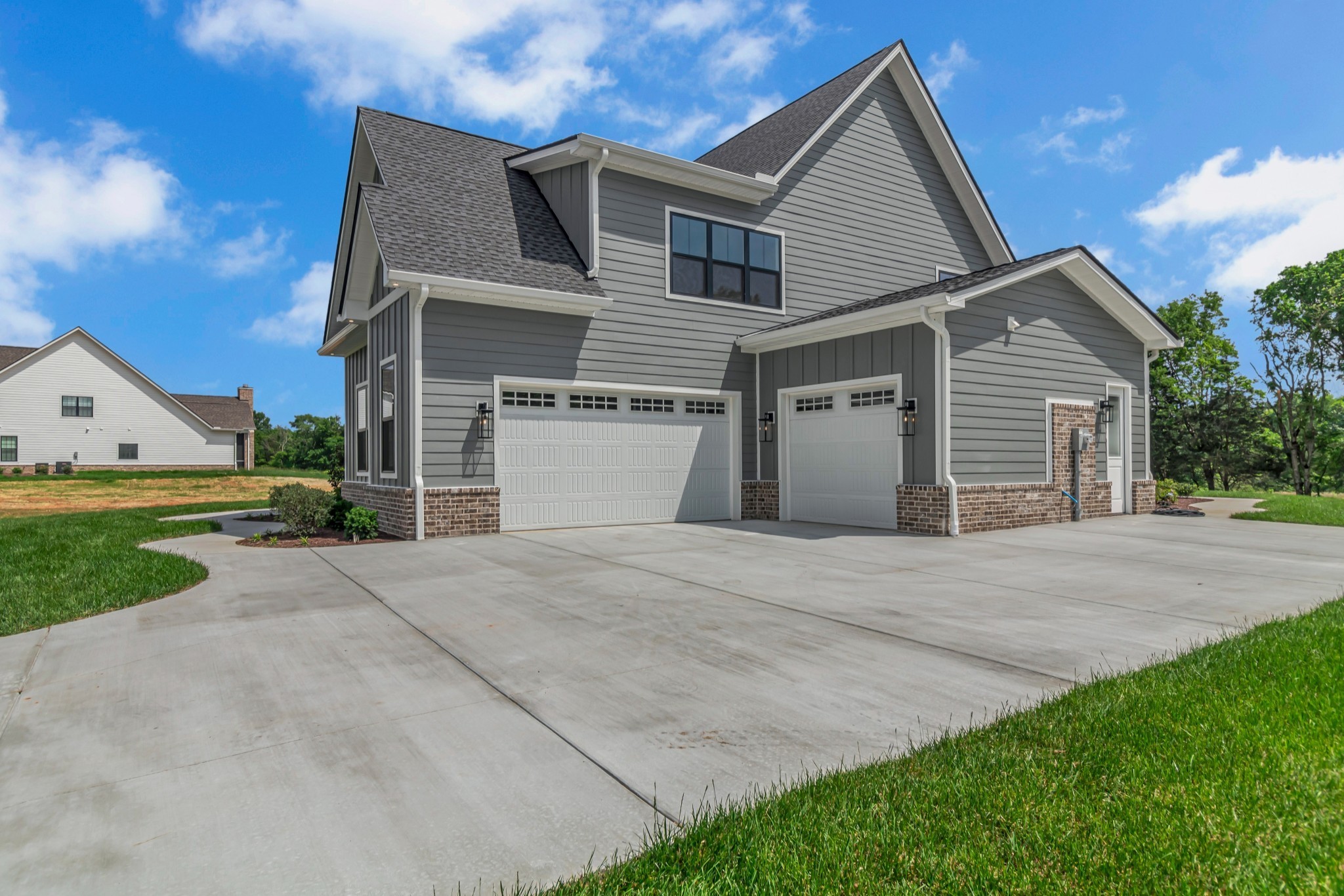 7004 Twelve Corners Road Lascassas, TN 37085 - Photo 9 of 67 a front view of a house with a yard and garage