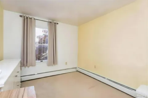 a large white bed in a white room