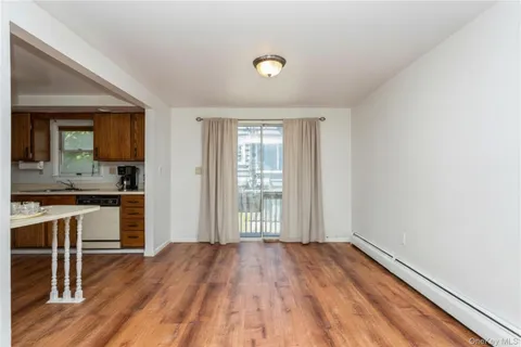 a view of kitchen with wooden floor and electronic appliances