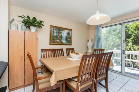 a view of a dining room with furniture and a potted plant