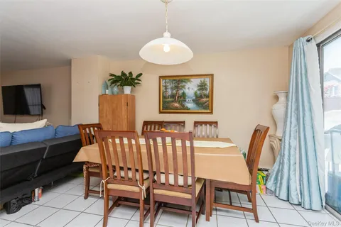 a view of a dining room with furniture and a window