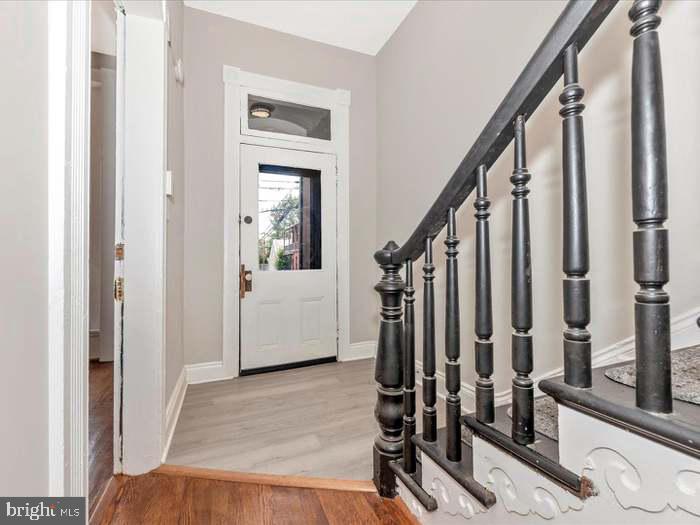 101 East 3rd Street, Unit 3 Frederick, MD 21701 - Photo 2 of 11 a view of a hallway with wooden floor and staircase