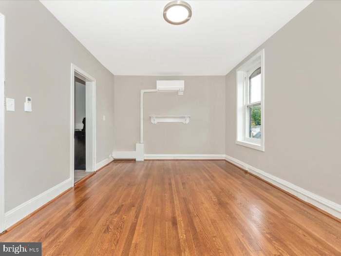 101 East 3rd Street, Unit 3 Frederick, MD 21701 - Photo 3 of 11 an empty room with wooden floor and windows