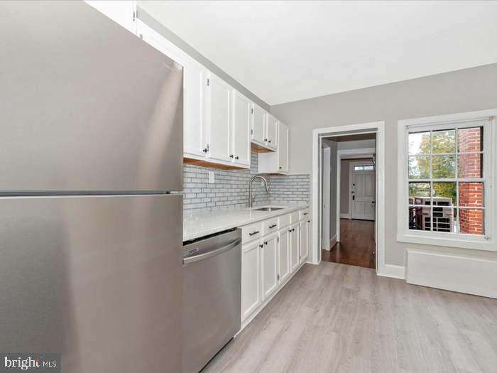 101 East 3rd Street, Unit 3 Frederick, MD 21701 - Photo 4 of 11 a kitchen with granite countertop white cabinets and white appliances