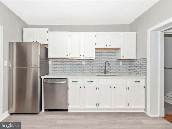 101 East 3rd Street, Unit 3 Frederick, MD 21701 - Photo 5 of 11 a kitchen with stainless steel appliances granite countertop a refrigerator and a stove