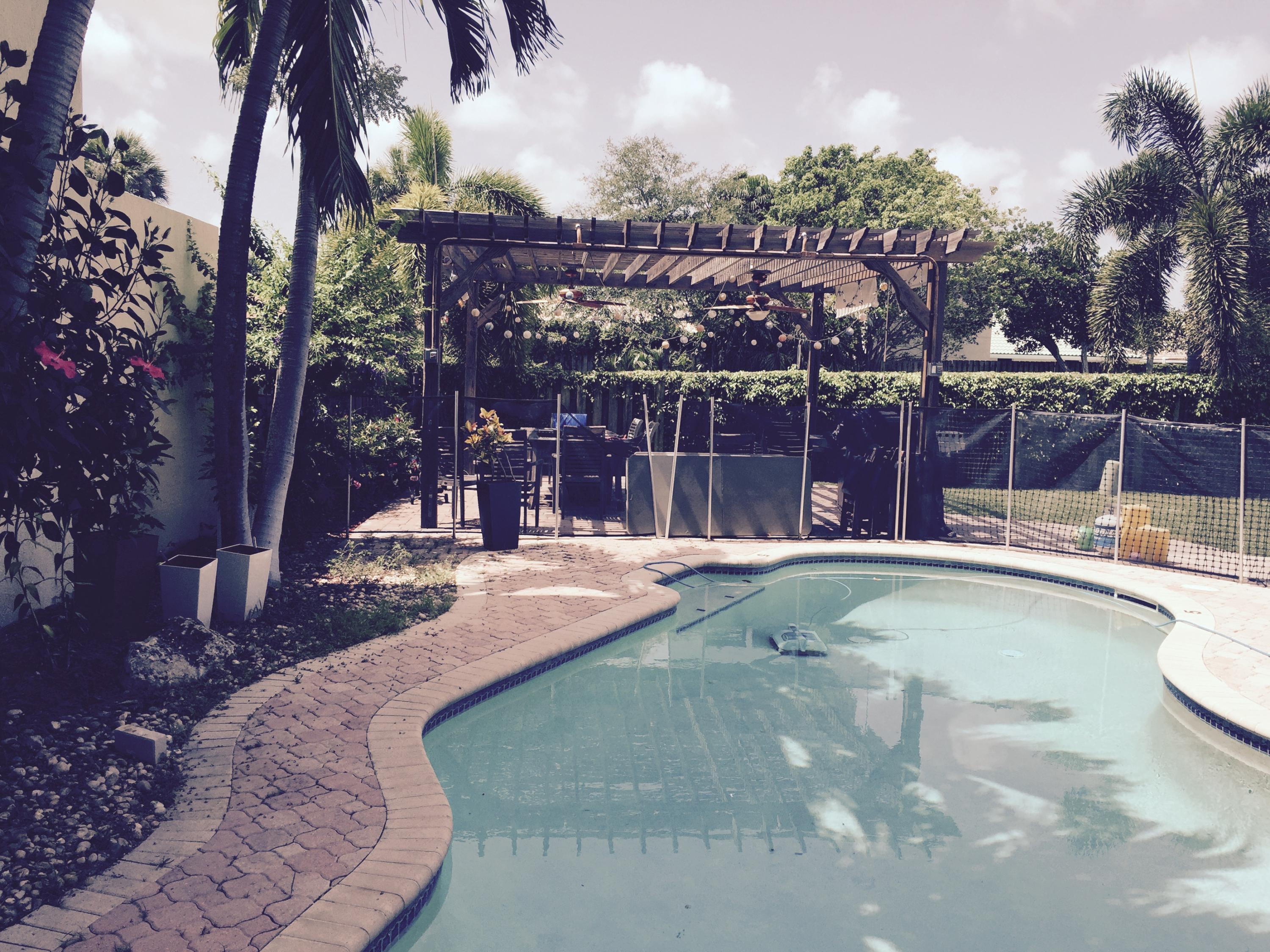 22380 Dorado Drive Boca Raton, FL 33433 - Photo 16 of 17 view from the pool to the pergola