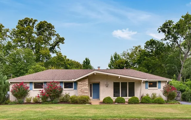 a front view of a house with a garden