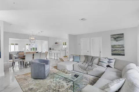 a living room with furniture and a dining table