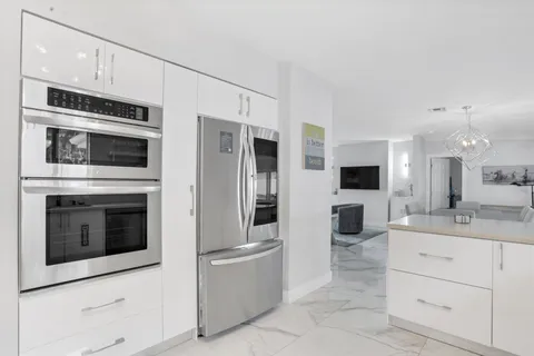 a kitchen with stainless steel appliances a stove microwave and refrigerator