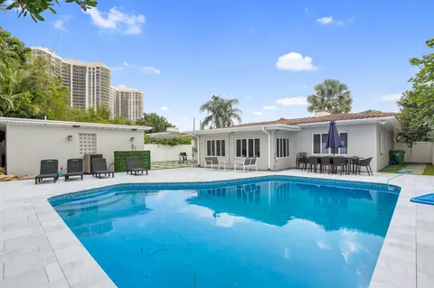 a front view of a house with swimming pool having outdoor seating