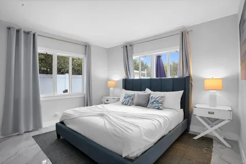 a bedroom with a bed and window