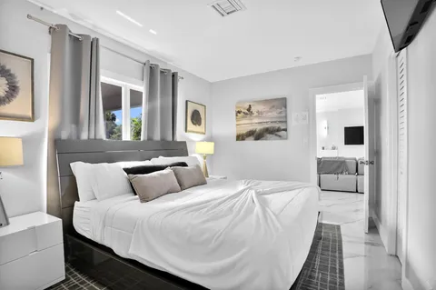 a bedroom with a large bed and a couch