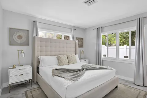 a bedroom with a bed and a window