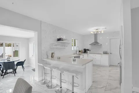 a kitchen with stainless steel appliances a sink stove and cabinets
