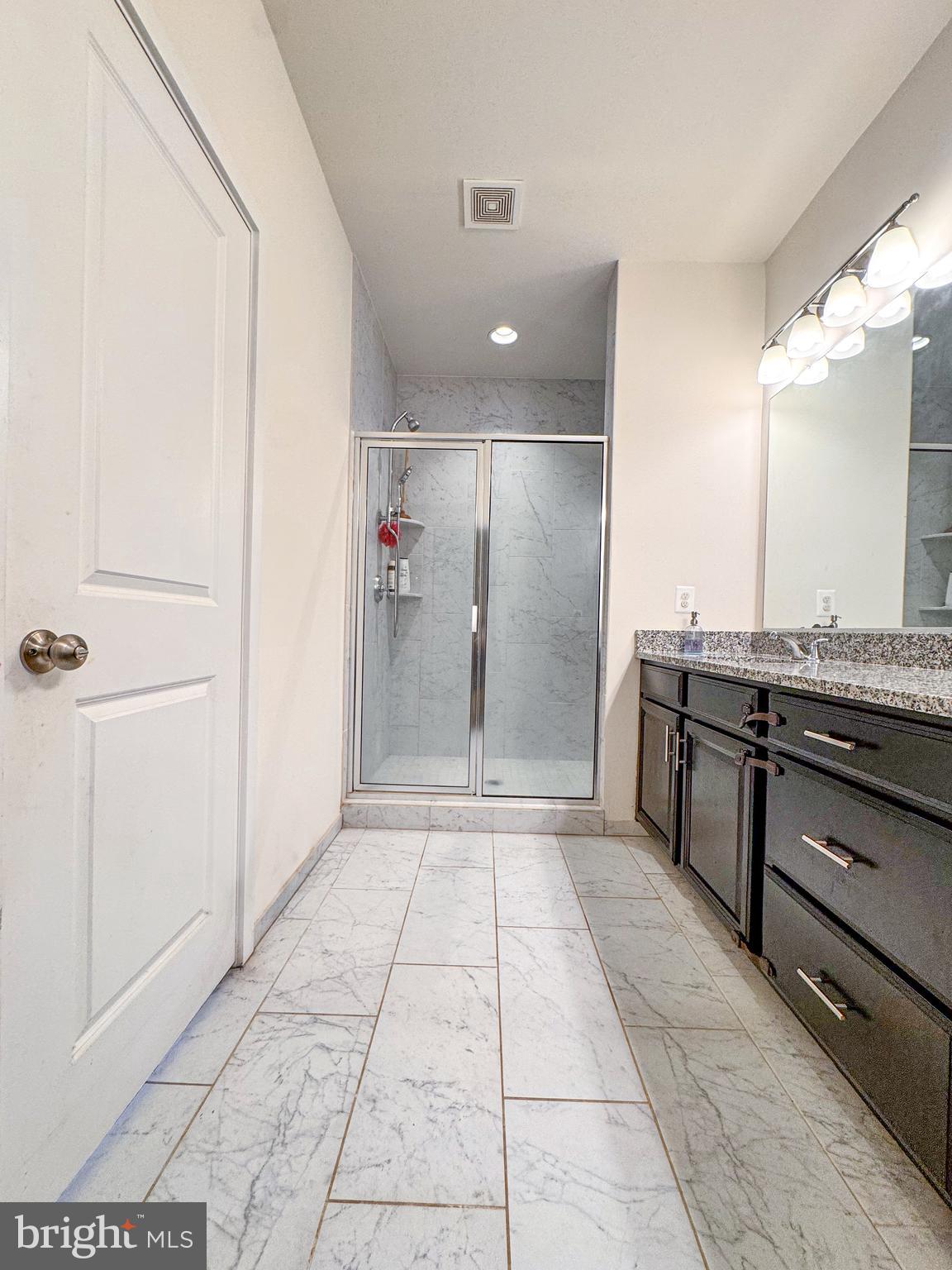 25419 Reed Orchard Terrace Chantilly, VA 20152 - Photo 33 of 47 a bathroom with a granite countertop sink a toilet and shower