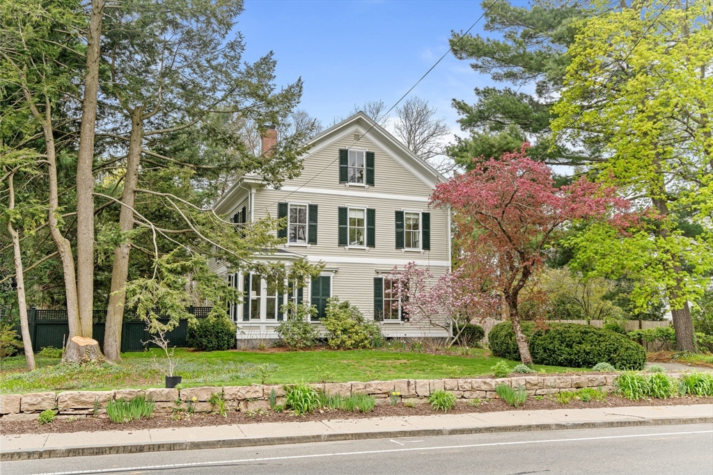 a front view of a house with a garden