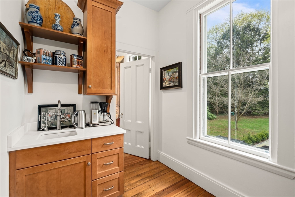 135 Court Street Dedham, MA 02026 - Photo 13 of 40 a kitchen with stainless steel appliances white cabinets and a window