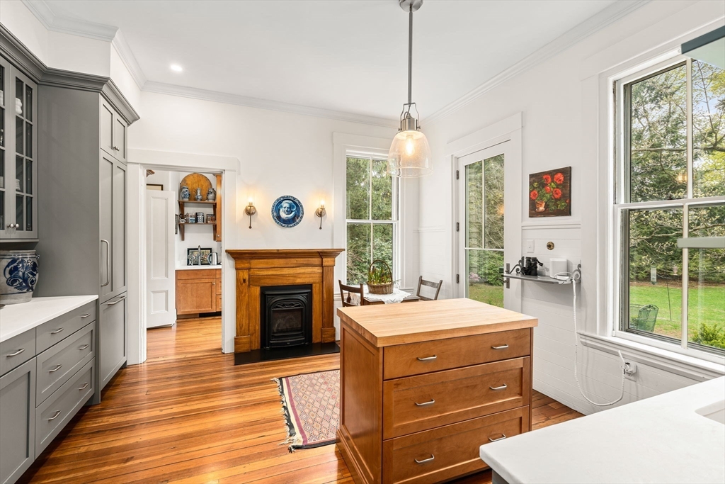 135 Court Street Dedham, MA 02026 - Photo 17 of 40 a room with furniture a fireplace and a chandelier