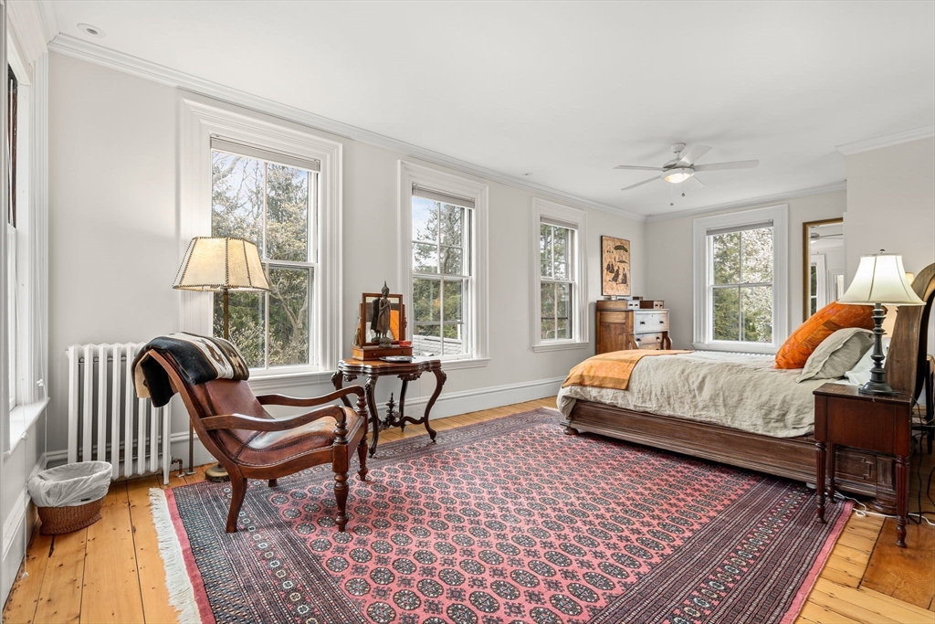 135 Court Street Dedham, MA 02026 - Photo 21 of 40 a bedroom with a bed and wooden floor
