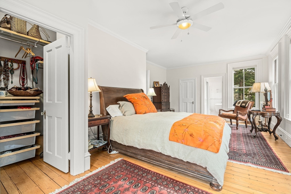 135 Court Street Dedham, MA 02026 - Photo 22 of 40 a bedroom with a bed and wooden floor