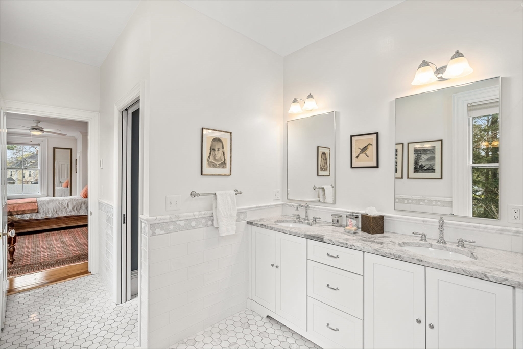 135 Court Street Dedham, MA 02026 - Photo 24 of 40 a bathroom with double vanity sink and a mirror