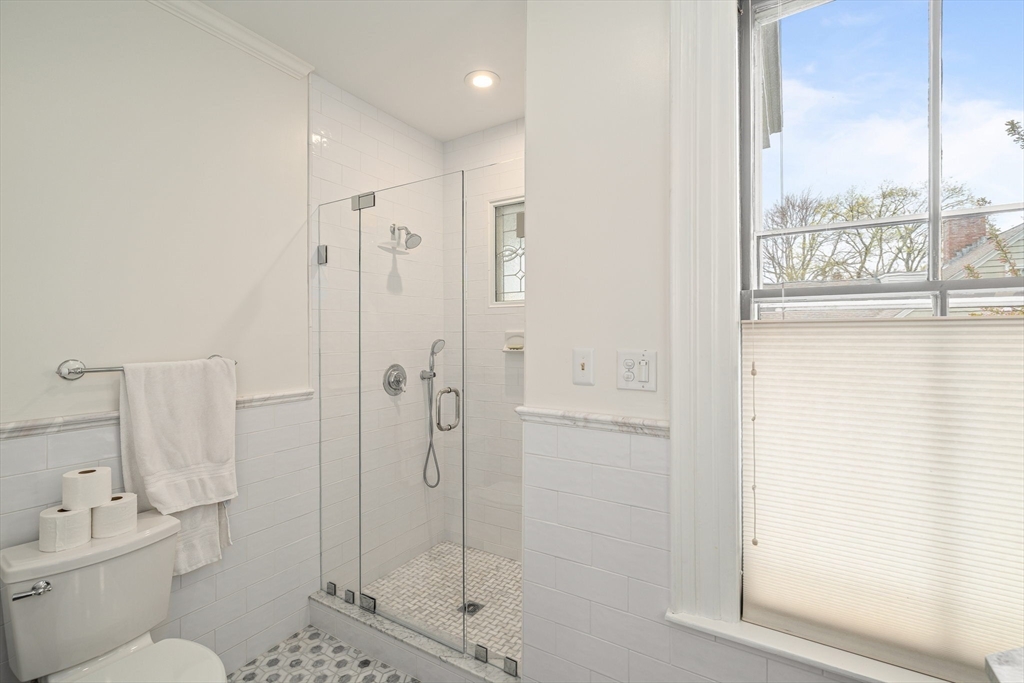 135 Court Street Dedham, MA 02026 - Photo 26 of 40 a bathroom with a shower and a toilet