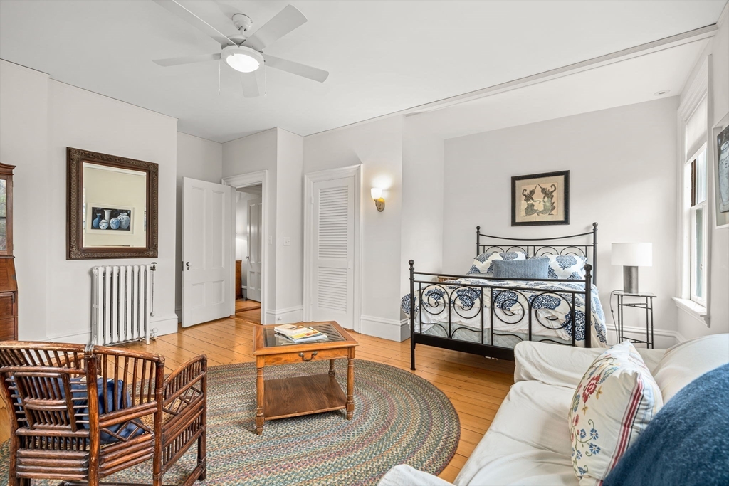 135 Court Street Dedham, MA 02026 - Photo 30 of 40 a bedroom with furniture and a wooden floor