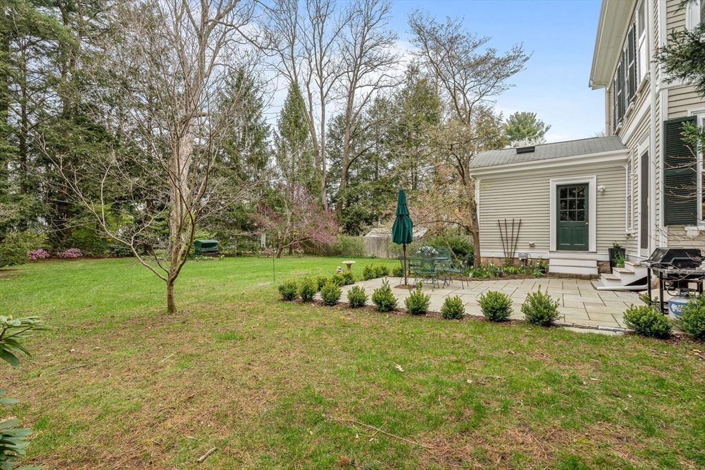 135 Court Street Dedham, MA 02026 - Photo 35 of 40 a backyard of a house with table and chairs