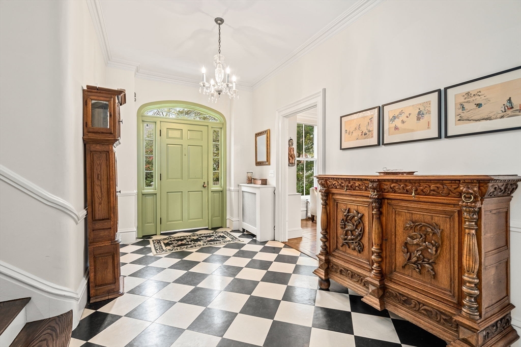 135 Court Street Dedham, MA 02026 - Photo 4 of 40 a view of a entryway door with chandelier